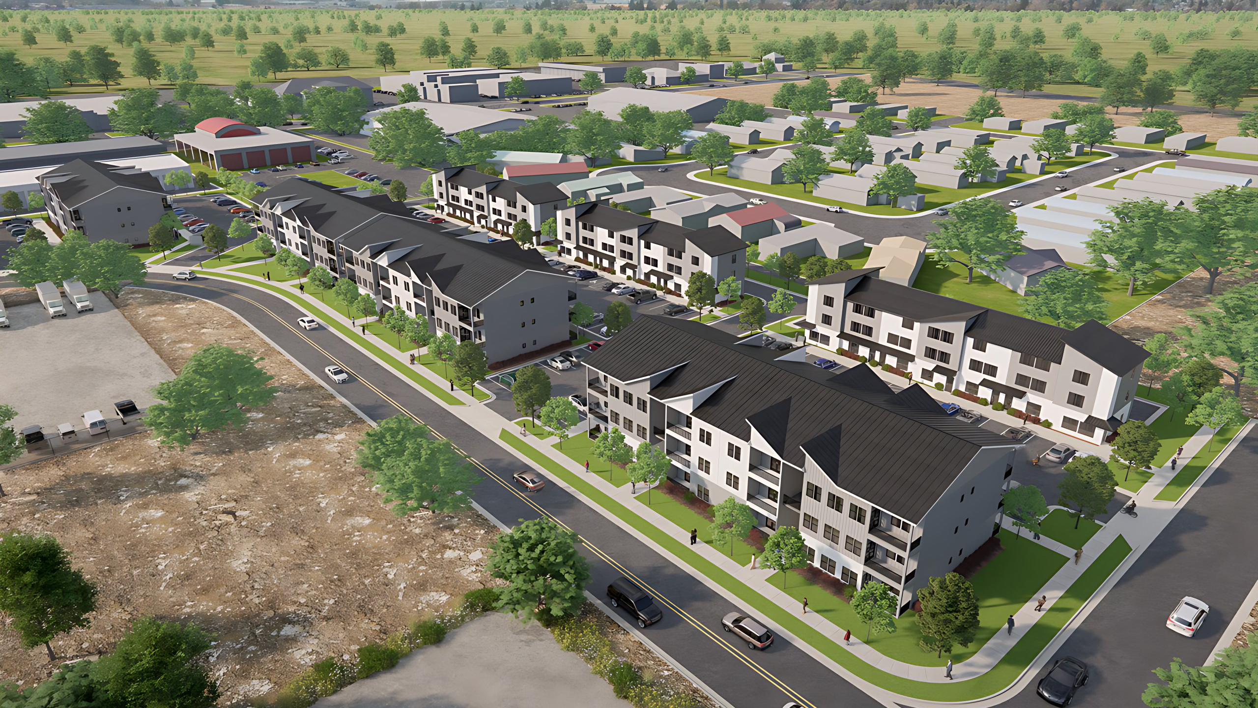 Aerial artist's rendering of Homes at the Falls: three-story apartment buildings and townhome rows on one site, with mountains on the skyline